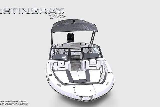 Slide: The Image of A modern Stingray 20 SBX boat with an open deck and black sunshade. - 28