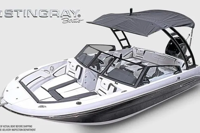 Slide: The Image of A modern Stingray 20 SBX bowrider with a gray sunshade and sleek design. - 29