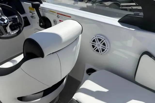 Slide: The Image of The image shows a boat interior with white and black seating and a speaker. - 19