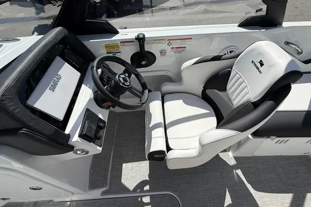 Slide: The Image of The image shows the cockpit of a 2027 Stingray 20 SBX boat with a sleek white seat. - 12