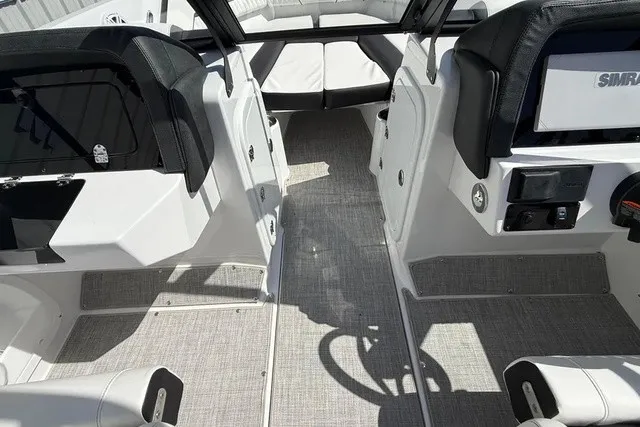 Slide: The Image of Interior view of a modern boat with gray carpet flooring and black seating. - 13