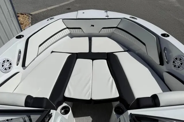 Slide: The Image of The image shows the bow area of a 2027 Stingray 20 SBX boat with white and black upholstery. - 7