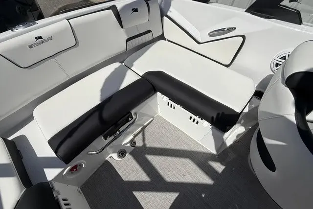 Slide: The Image of The image shows the interior of a Stingray 20 SBX boat with white and black seating. - 17