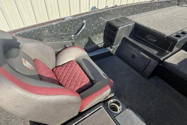 Slide: The Image of The image shows the interior of a 2019 Triton 20 TrX Patriot boat with a cushioned seat. - 12