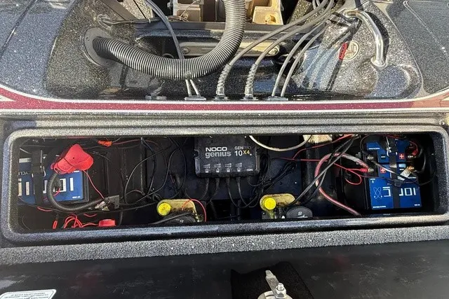 Slide: The Image of The image shows the engine compartment of a 2019 Triton 20 TrX Patriot with batteries and wiring. - 16