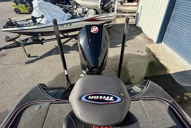 Slide: The Image of A 2019 Triton 20 TrX Patriot is parked on a lot. The engine is visible. - 10