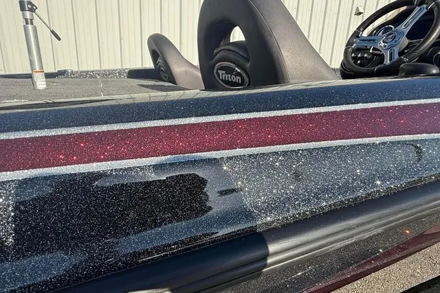 Slide: The Image of Close-up of a 2019 Triton 20 TrX Patriot with a sparkling hull and steering wheel. - 4