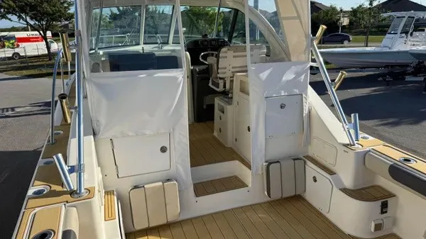 Slide: The Image of The image shows the cockpit of a 2007 Pursuit OS 335 Offshore with wooden flooring and seating area. - 10