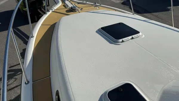 Slide: The Image of The image shows the deck of a 2007 Pursuit OS 335 Offshore with sleek lines and stainless steel railings. - 23