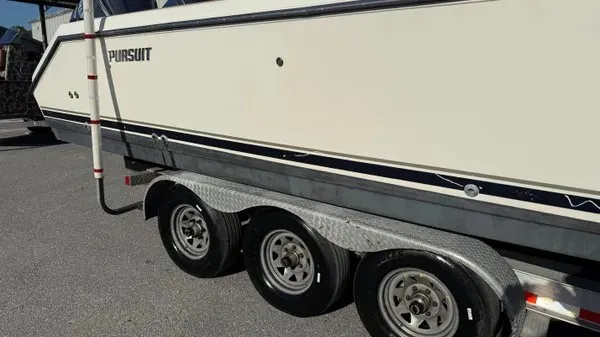 Slide: The Image of A 2007 Pursuit OS 335 Offshore boat on a triple-axle trailer. - 2