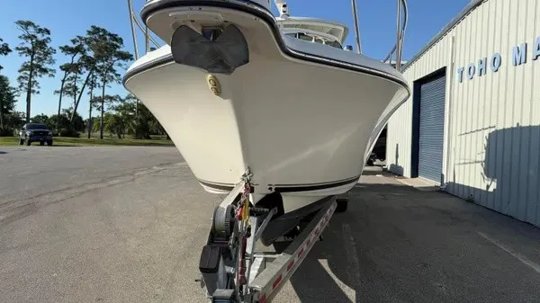 Slide: The Image of A 2007 Pursuit OS 335 Offshore boat on a trailer next to a building. - 7