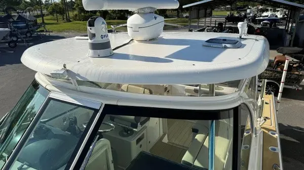 Slide: The Image of The image shows the roof of a 2007 Pursuit OS 335 Offshore boat with radar equipment. - 25