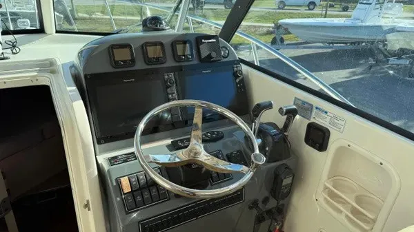 Slide: The Image of Helm of a 2007 Pursuit OS 335 Offshore with modern instruments and steering wheel. - 21