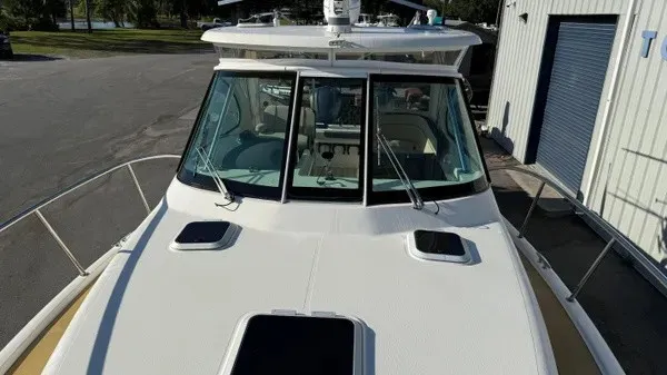 Slide: The Image of The 2007 Pursuit OS 335 Offshore features a spacious deck with clear windows and sturdy railings. - 24