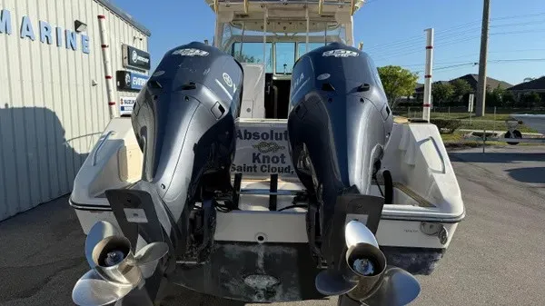 Slide: The Image of Two outboard engines on a 2007 Pursuit OS 335 Offshore boat, parked in a lot. - 3