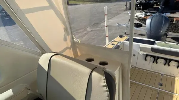 Slide: The Image of The image shows the cockpit of a 2007 Pursuit OS 335 Offshore with beige seats and cup holders. - 18