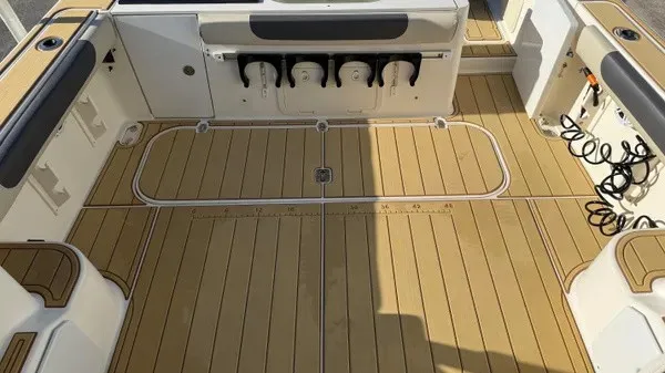 Slide: The Image of The image shows the cockpit of a 2007 Pursuit OS 335 Offshore with wood flooring and storage. - 20