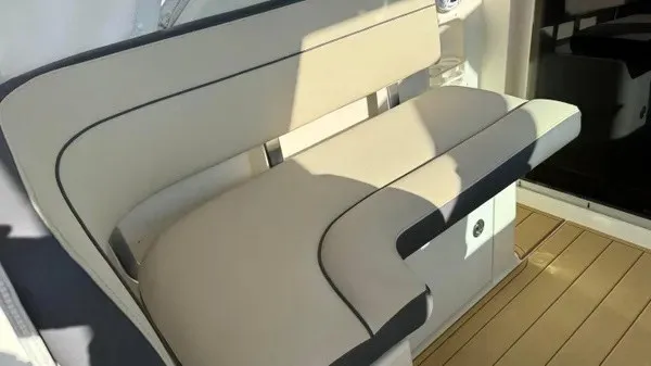 Slide: The Image of The seating on the 2007 Pursuit OS 335 Offshore features cream upholstery with dark accents. - 12