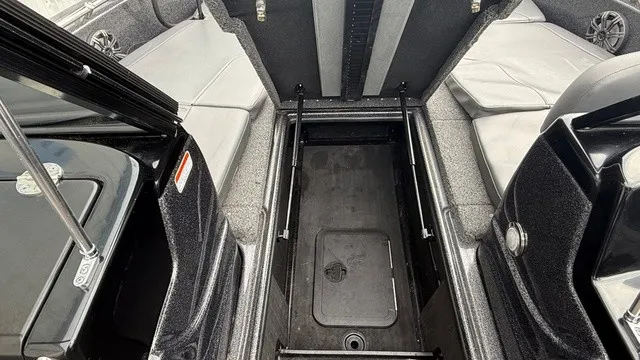Slide: The Image of The image shows the interior of a 2022 Nitro ZV19 boat with an open storage compartment. - 12