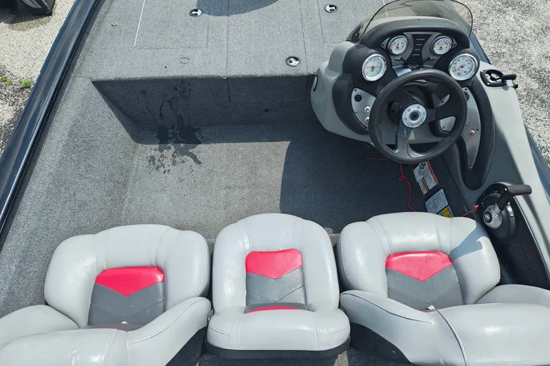 Slide: The Image of 2016 Tracker Pro Team 175 TXW boat interior with steering console and three seats. - 7