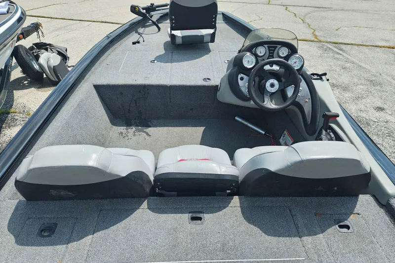 Slide: The Image of 2016 Tracker Pro Team 175 TXW boat interior with steering console and seating. - 6