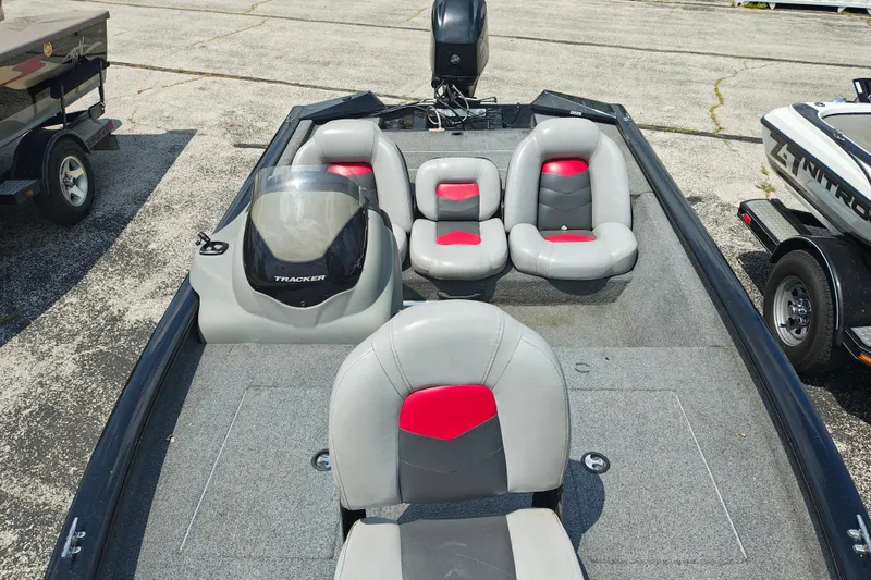 Slide: The Image of 2016 Tracker Pro Team 175 TXW boat interior with gray and red seating. - 13