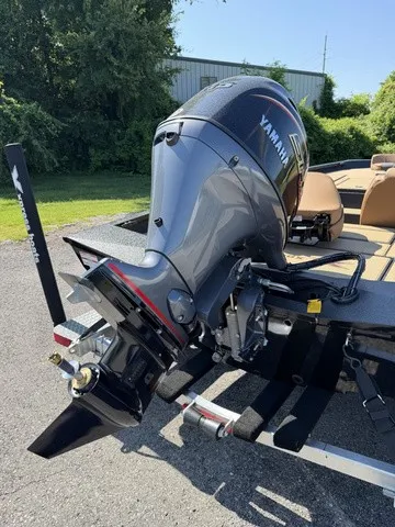 Slide: The Image of A powerful outboard motor on an Xpress Hyper-Lift Bass H18 boat, surrounded by green vegetation. - 3
