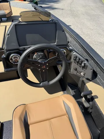 Slide: The Image of The image shows the cockpit of an Xpress Hyper-Lift Bass H18 boat with a modern steering wheel and instruments. - 8