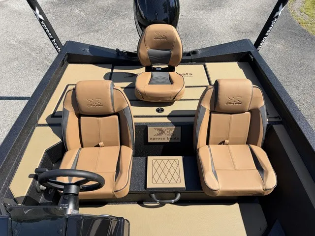 Slide: The Image of The image shows the cockpit of an Xpress Hyper-Lift Bass H18 boat with beige leather seats. - 9