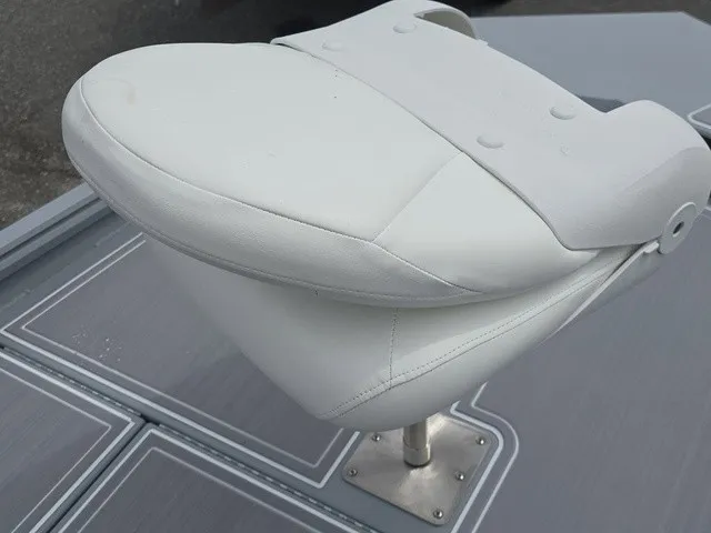 Slide: The Image of A white boat seat on a gray deck, mounted on a metal pedestal. - 20