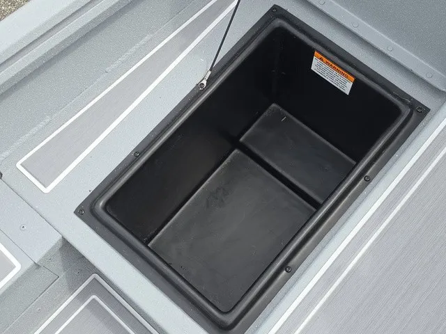 Slide: The Image of An open storage compartment on a gray boat, featuring a black interior. - 16