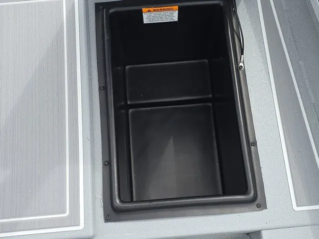 Slide: The Image of An open storage compartment on a 2026 G3 Bay 17 boat, featuring a gray deck. - 18