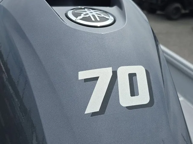 Slide: The Image of Close-up of a gray outboard motor with the number 70. - 12
