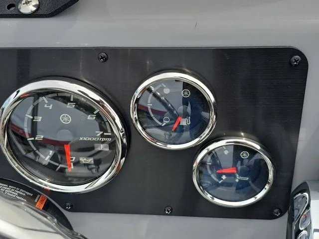 Slide: The Image of Close-up of three round gauges on a boat panel, including a tachometer. - 27