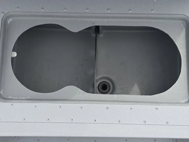 Slide: The Image of An empty, oval storage compartment on a 2026 G3 Bay 17 boat. - 17