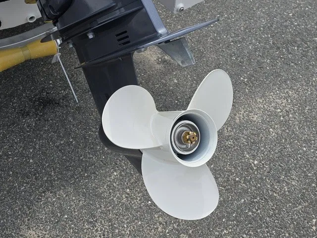 Slide: The Image of Close-up of a boat propeller on asphalt. The propeller has three white blades. - 13