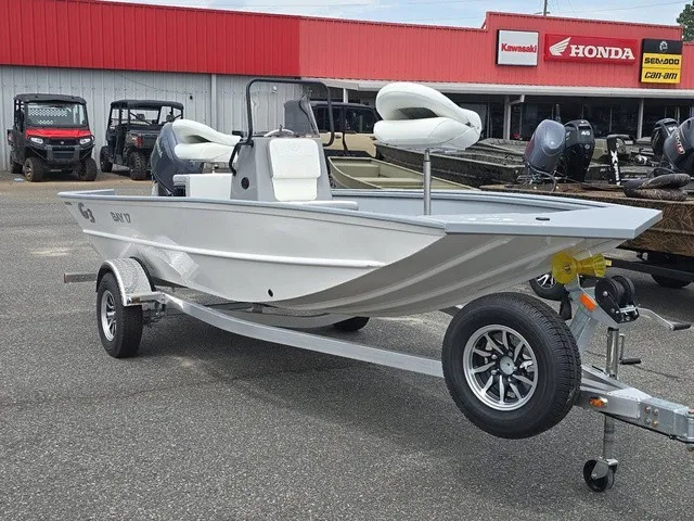 Slide: The Image of A 2026 G3 Bay 17 boat on a trailer in front of a store with Honda and Kawasaki signs. - 5