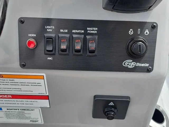Slide: The Image of Control panel of a G3 Bay 17 boat with various switches and warning labels. - 29