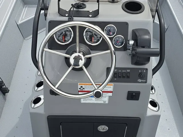 Slide: The Image of The image shows the helm of a G3 Bay 17 boat with a modern steering wheel and gauges. - 14