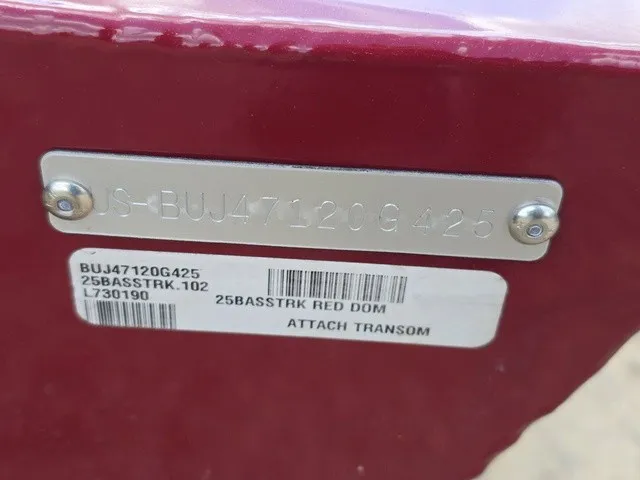 Slide: The Image of Close-up of a boat serial number plate on a red background. - 30