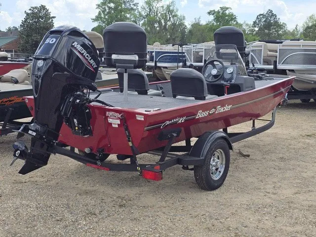 Slide: The Image of A red 2025 Bass Tracker Classic XL boat on a trailer. It features a Mercury engine. - 5