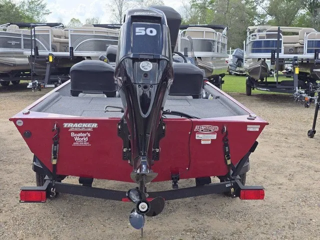 Slide: The Image of A red Tracker Bass Tracker Classic XL boat from 2025 with a 50 HP motor on a trailer. - 6