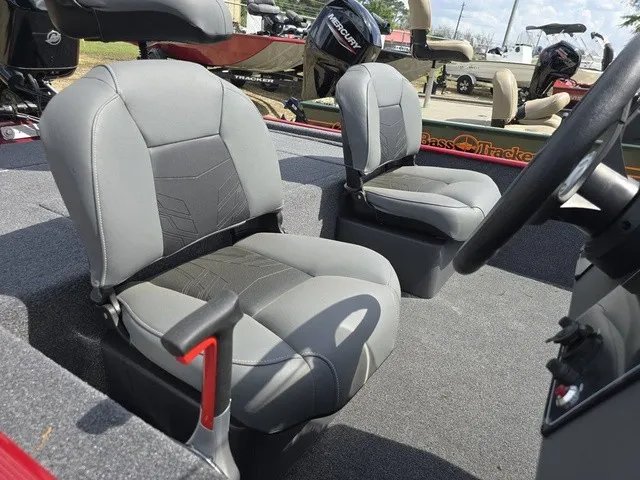 Slide: The Image of Two gray seats in a 2025 Tracker Bass Tracker Classic XL boat, with a motor in the background. - 26