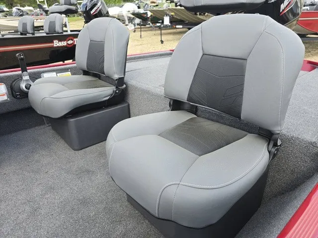 Slide: The Image of Two gray seats in a boat, with carpeted flooring and a control console in the background. - 18