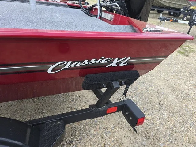 Slide: The Image of Red boat with "Classic XL" lettering, parked on a trailer. - 13