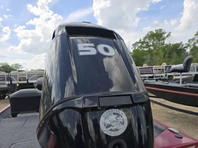 Slide: The Image of A black outboard motor labeled "50" is mounted on a boat. - 10