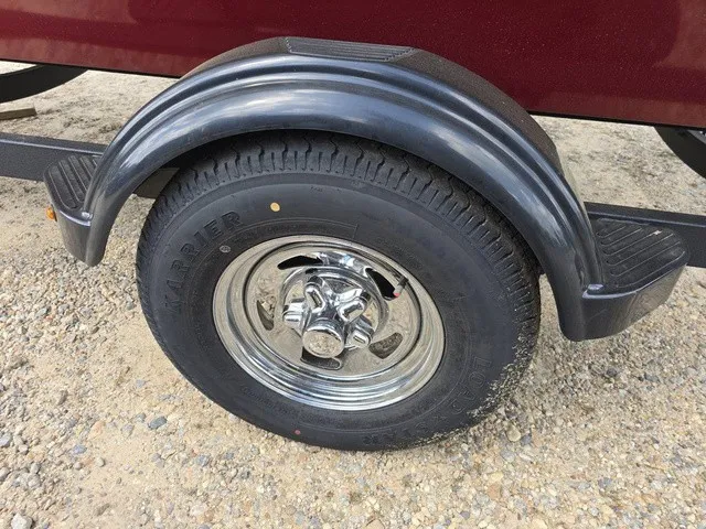 Slide: The Image of Close-up of a boat trailer wheel with a shiny chrome rim and sturdy tire. - 14
