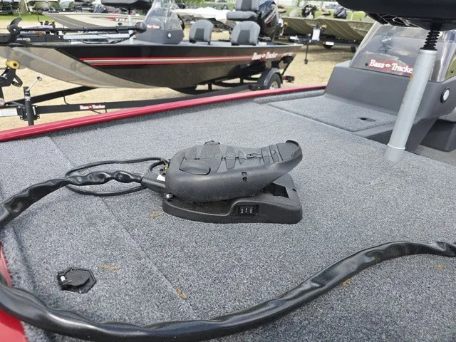 Slide: The Image of A gray carpeted deck on a boat with a black pedal and cables. Other boats in the background. - 22