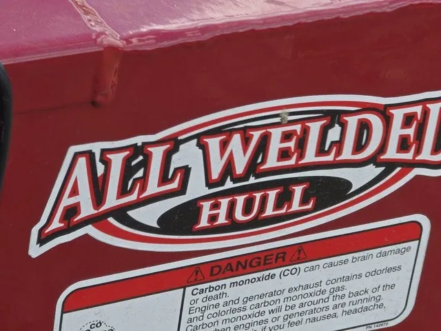 Slide: The Image of Close-up of a sticker on a red boat with carbon monoxide warnings. - 11