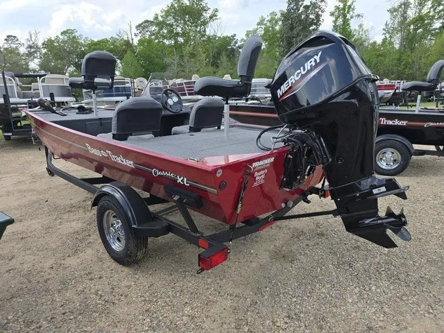 Slide: The Image of A red 2025 Bass Tracker Classic XL boat on a trailer. It features a Mercury outboard motor. - 7